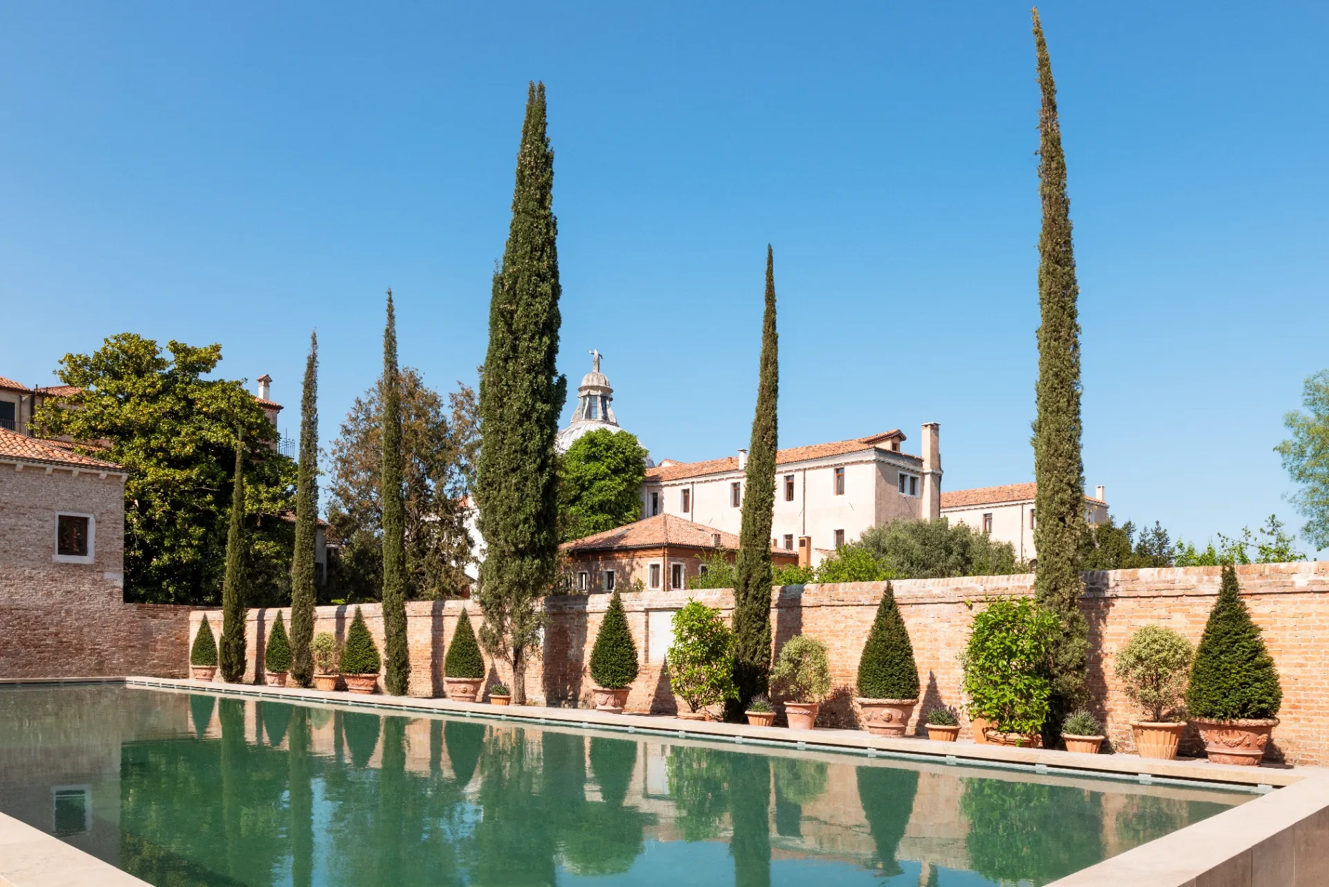 The extensive grounds of the Airelles Palladio Venice include an open-air pool