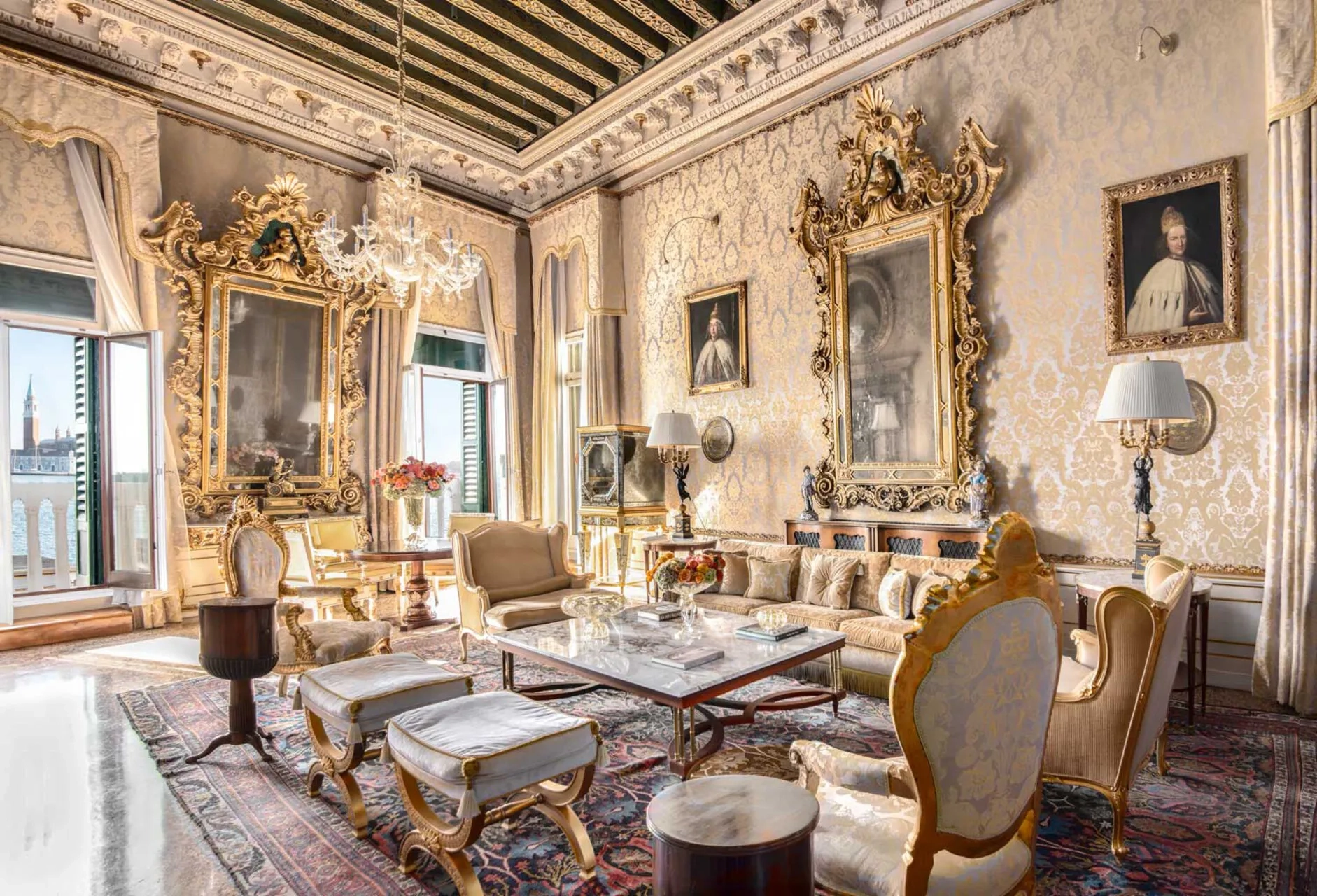 Gilt-framed mirrors and inlaid ceilings are features of the glamorous royal suite at the Danieli Venezia, a Four Seasons hotel